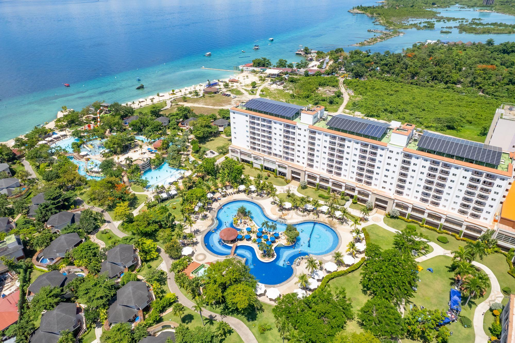 Aerial view of JPark Island Resort and Waterpark beside the blue waters of Mactan, Cebu